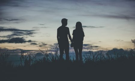 Moon conjunct Venus synastry - Silhouette of couple holding hands.